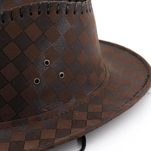 Detail of brown checkerboard cowboy hat with metal air vents and stitched edges