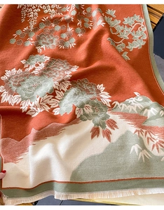 Close-up of thick floral cashmere-feel scarf with oriental patterns and tassel trim