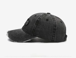 Side view of distressed washed denim baseball cap with vintage ripped details and embroidery