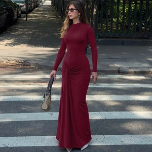 Detail of elegant wine red long sleeve dress featuring waist knot and drape design