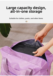 Large purple Oxford cloth travel bag showing spacious interior packed with folded clothes