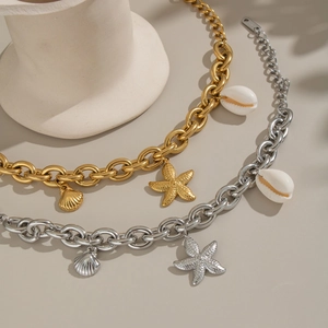 Chunky stainless steel nautical bracelet with gold and silver shell and starfish charms
