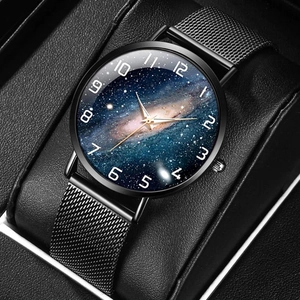 Close-up of black mesh metal strap and galaxy star dial watch on a presentation pillow