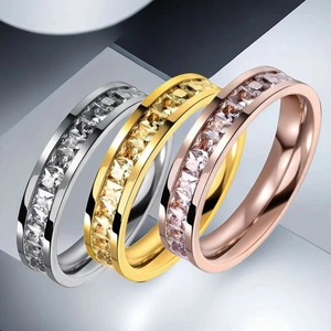 Detail of square-cut crystals set in stainless steel rings in silver gold and rose gold