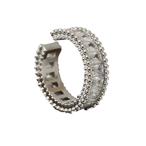Luxurious silver open ring with rectangle-cut zircons and beaded edge on white background