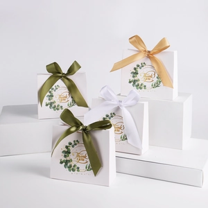 Minimalist white gift bags with eucalyptus print, gold ribbons and Thank You gold lettering