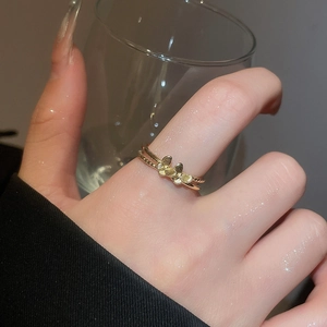 Macro shot of gold butterfly ring with double-band design and micro-decorations