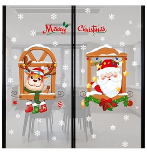 Close-up of festive Christmas window stickers with Santa Claus and reindeer on glass doors