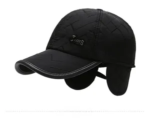 Close-up of black quilted winter baseball cap featuring earflaps and metal JEANS emblem