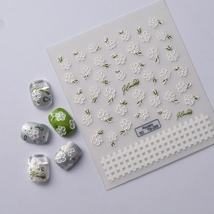 Detail of 5D embossed camellia nail stickers with white flowers and green leaves