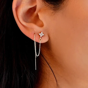 Macro shot of S925 silver four-leaf clover tassel earrings with cubic zirconia stones