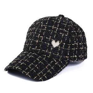 Elegant black and gold tweed baseball cap for women featuring a pearl heart accent