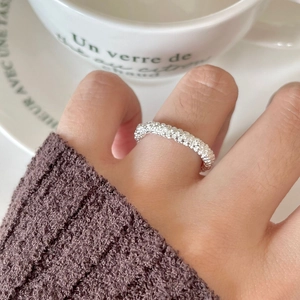 Close-up of minimalist 925 sterling silver ring with beaded texture on model finger