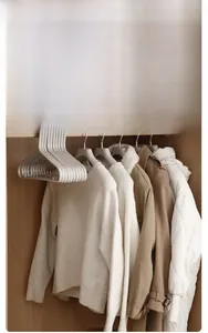 Ultra-slim non-slip hangers in light gray saving seventy-five percent closet space