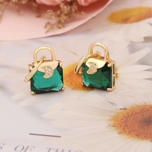 Chic gold earrings with emerald green bag design and crescent moon zircon details