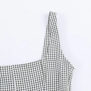 Detail view of the black and white plaid dress featuring an invisible side zipper closure
