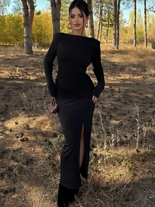 Detail of elegant black slim fit dress featuring pleated waist and high side slit design