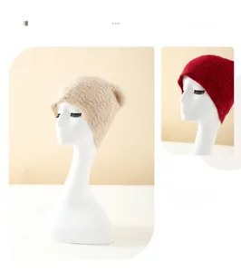 Detail of cable knit pattern on pure cashmere beanies in beige and burgundy colors