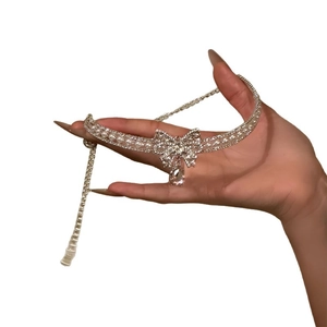 Elegant silver choker necklace with rhinestones, pearls, and a crystal bow drop pendant