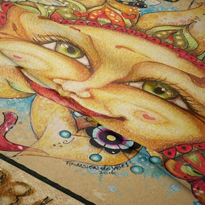 Detail of artistic bohemian tapestry fabric featuring sun illustration and artist signature