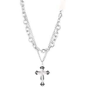 Detail of layered silver punk chain featuring a rhinestone cross pendant and black enamel