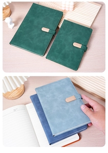 Detail of A5 business notebooks in green and blue colors with metal buckle and lined pages