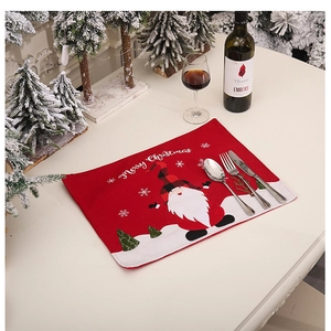 Christmas table mat detail with red cartoon Santa Claus and Merry Christmas embroidery