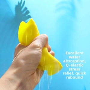 Close-up of yellow fish squeezy toy showing high elasticity and water drainage features