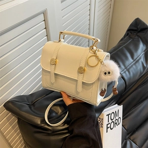 Retro cream white crossbody flap bag with gold hardware and plush ball charm decoration