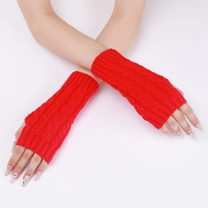 Macro view of red cable knit arm warmers showing thick braided texture and thumb hole