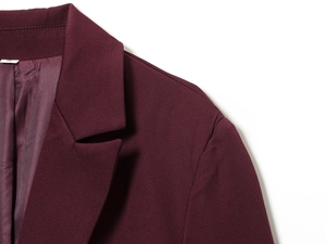 Detail of burgundy blazer showing shoulder pads, premium stitching, and inner lining