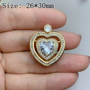 Detailed macro view of a 26x30mm gold heart pendant with inlaid rhinestones