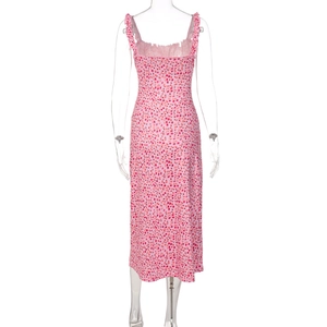 Detail of pink floral summer dress featuring delicate ruffles and bohemian flower print