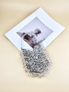 Close-up of a handmade clear acrylic beaded handbag with faceted crystal-like beads