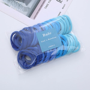 Detailed view of high-elasticity blue gradient seamless hair ties in a clear package