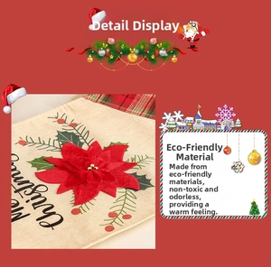 Close-up of a festive burlap Christmas table runner featuring 3D poinsettias and Merry Christmas text