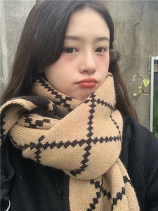 Close-up of camel and black checkered knit scarf texture on professional model
