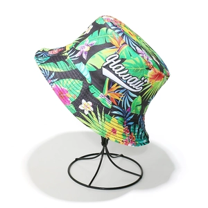 Detail of Hawaii embroidery and tropical floral patterns on a black sun bucket hat