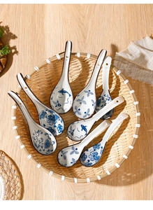 Close-up of ceramic spoons with blue and white floral patterns on a bamboo tray