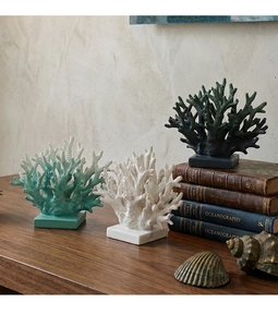 Detailed texture of resin coral sculptures in white and teal on elegant stands