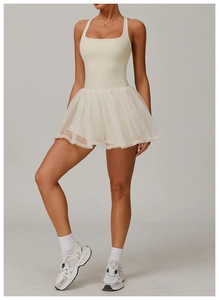 Detail of breathable white mesh tennis dress featuring a layered ballet-style skirt design