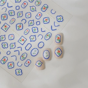 Blue porcelain frame and rose nail art stickers displayed on natural nails