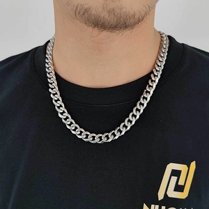 Classic 11mm silver stainless steel Cuban link chain necklace worn by a male model