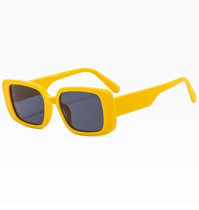 Detail view of vintage square yellow frame sunglasses with dark grey lenses at 45-degree angle
