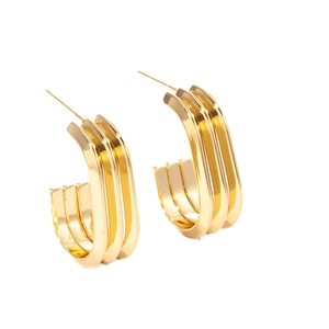 Detailed macro view of triple-layered golden wheat ear earrings with a polished mirror finish