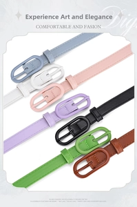 Detail view of colorful slim leather belts with oval buckles in various macaron colors