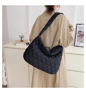 Rear view of a black quilted shoulder bag with diamond stitch patterns and high capacity