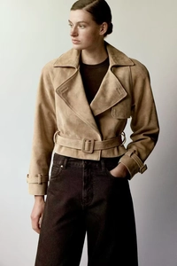 Close-up of beige suede short jacket with lapel collar and waist belt detail