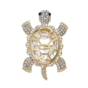 Detailed view of turtle brooch with faceted crystal and gold plated sparkling rhinestones