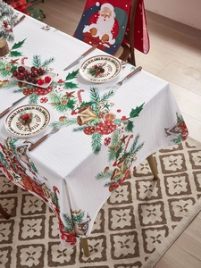 Detalle de un mantel navideño blanco con estampados de Papá Noel y campanas festivas